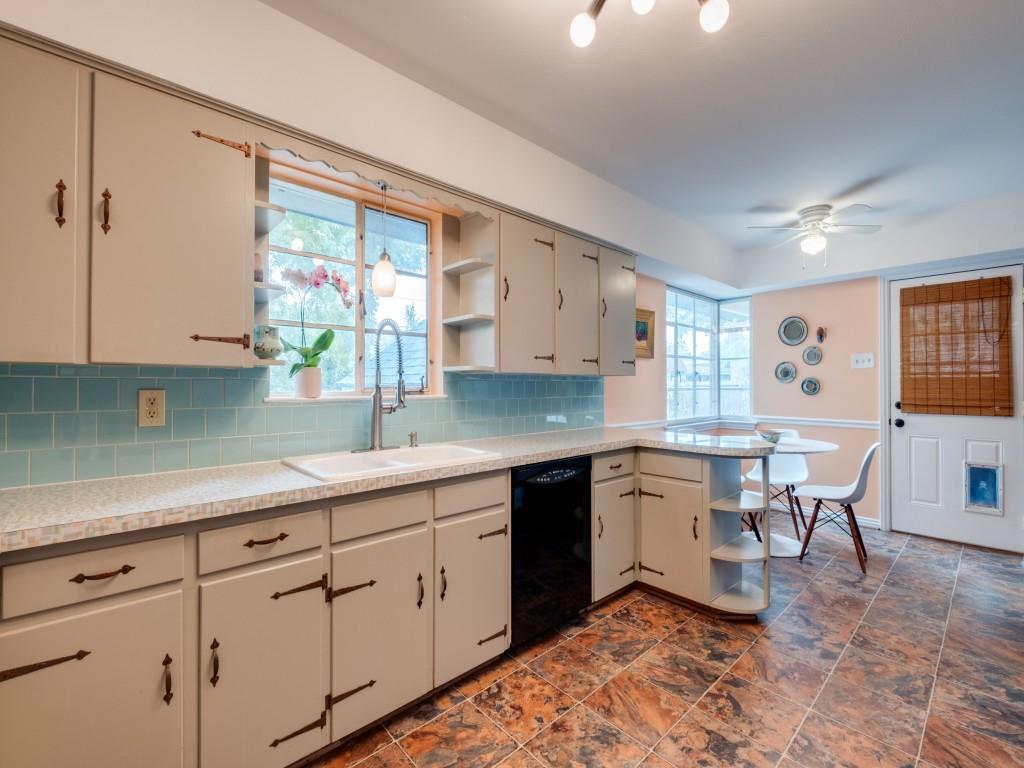 9753 Carnegie Drive Dallas, TX 75228 - Photo 14 of 25 a kitchen with white cabinets and sink