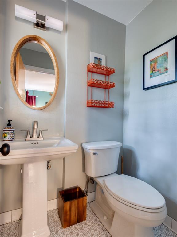 9753 Carnegie Drive Dallas, TX 75228 - Photo 17 of 25 a bathroom with a toilet a sink and a mirror