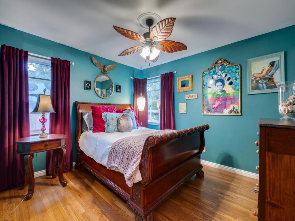 9753 Carnegie Drive Dallas, TX 75228 - Photo 18 of 25 a bedroom with a bed and wooden floor