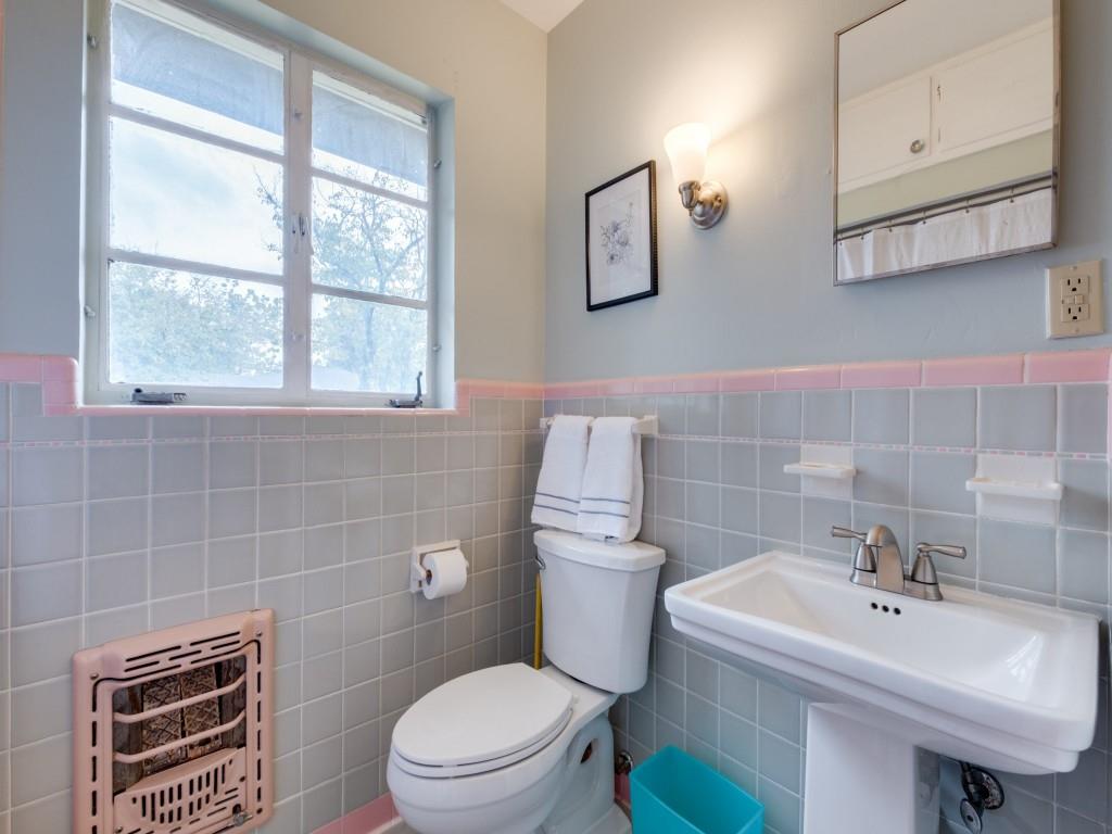 9753 Carnegie Drive Dallas, TX 75228 - Photo 22 of 25 a bathroom with a sink a toilet and a mirror
