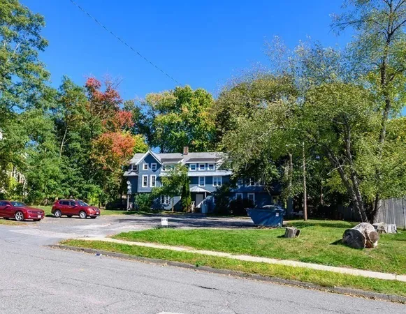 a front view of house with yard and green space