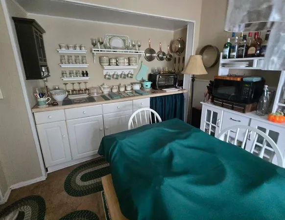 a kitchen with stainless steel appliances kitchen island granite countertop a sink and cabinets