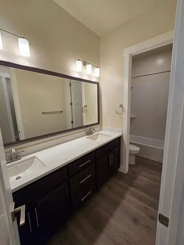 a bathroom with a double vanity sink and mirror