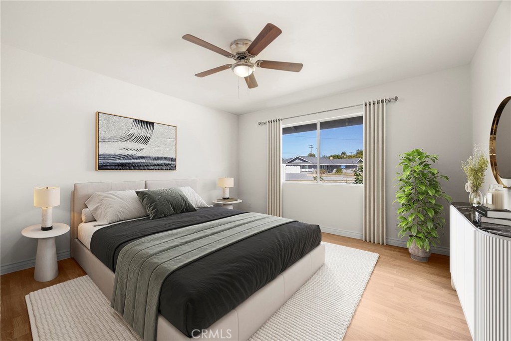 24582 Corta Cresta Drive Lake Forest, CA 92630 - Photo 19 of 26 a bedroom with a large bed and a potted plant