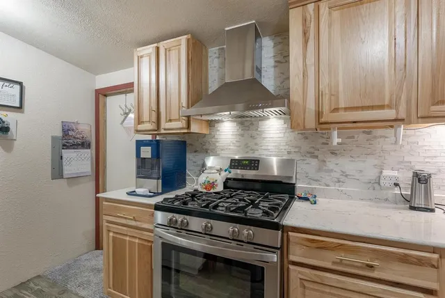 a stove top oven sitting inside of a kitchen