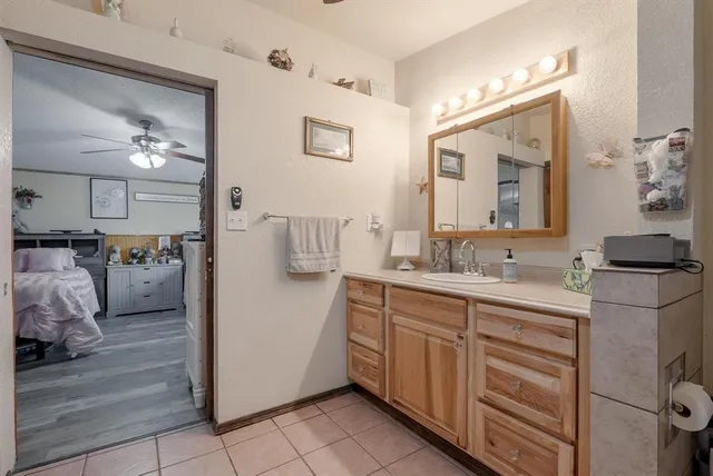 a spacious bathroom with a sink and a mirror