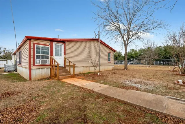 a view of backyard of house with green space