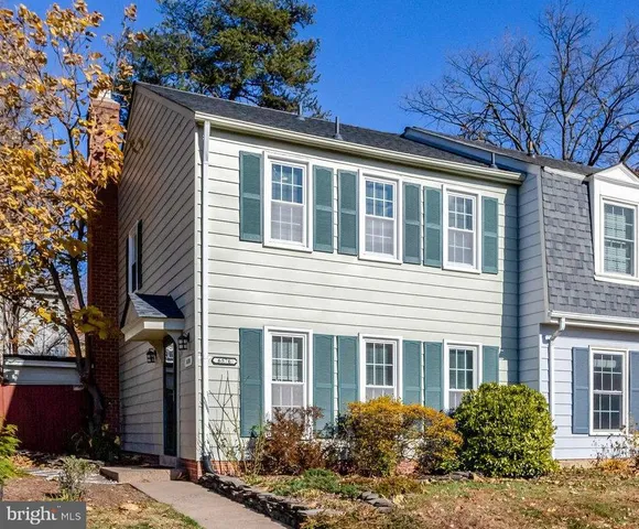 a view of a house with a yard and potted plants