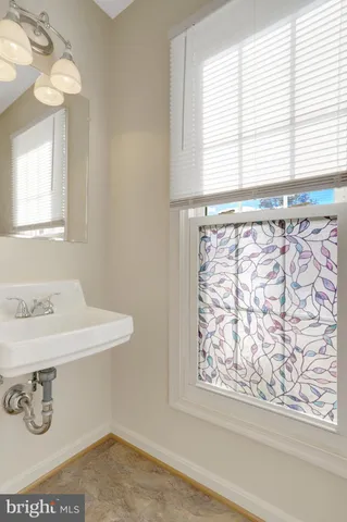 a bathroom with a sink and a window
