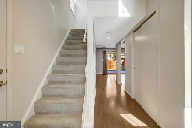 a view of entryway and hall with wooden floor