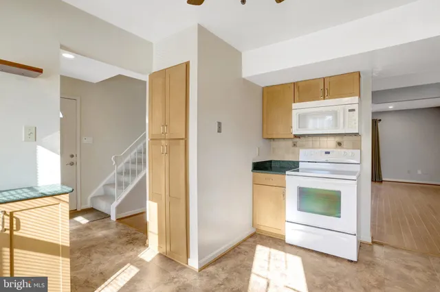 a kitchen with a stove and a refrigerator