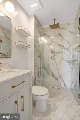 a bathroom with a toilet sink and shower