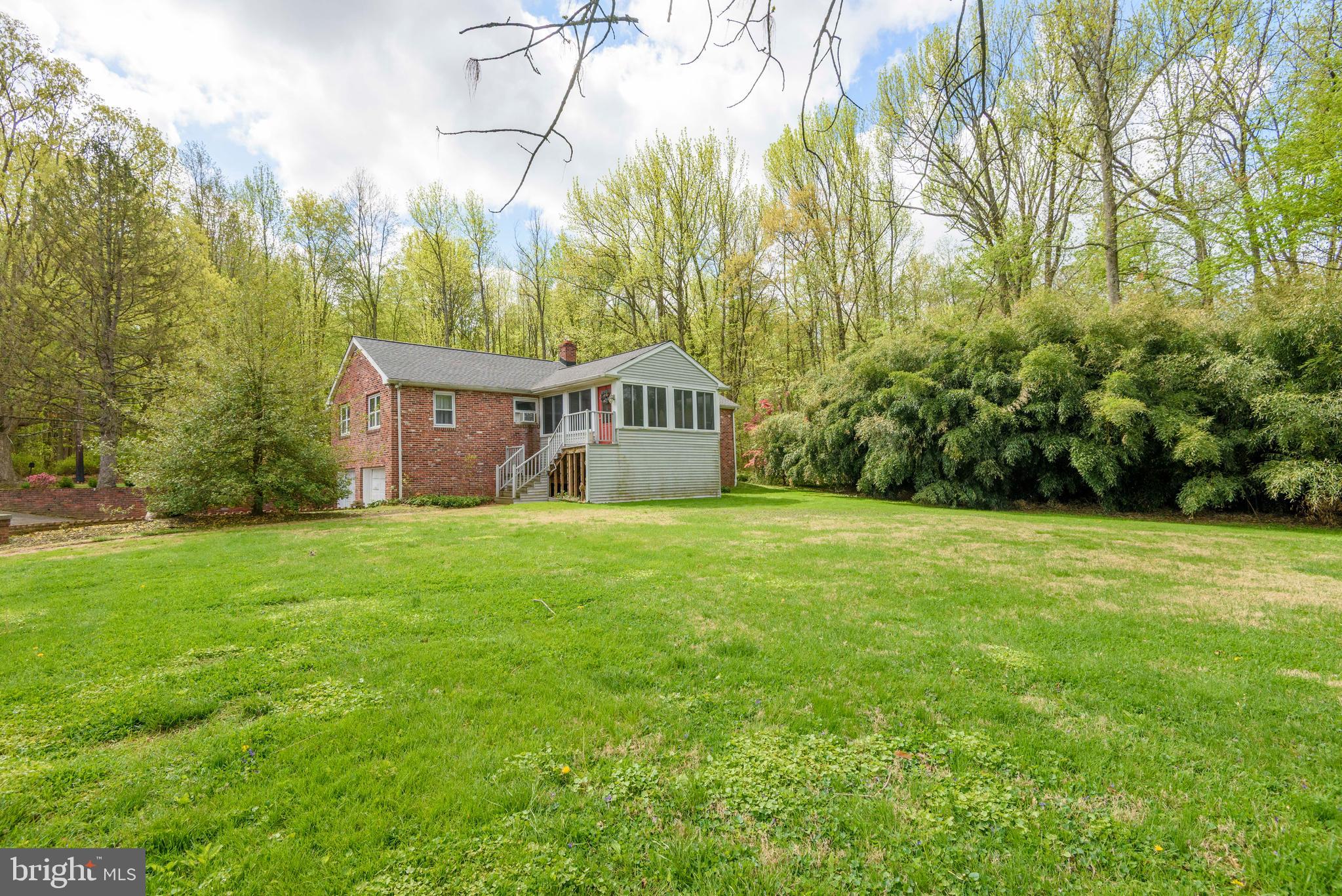 3463 Garnet Mine Road Garnet Valley, PA 19060 - Photo 26 of 38 a front view of a house with a yard and trees