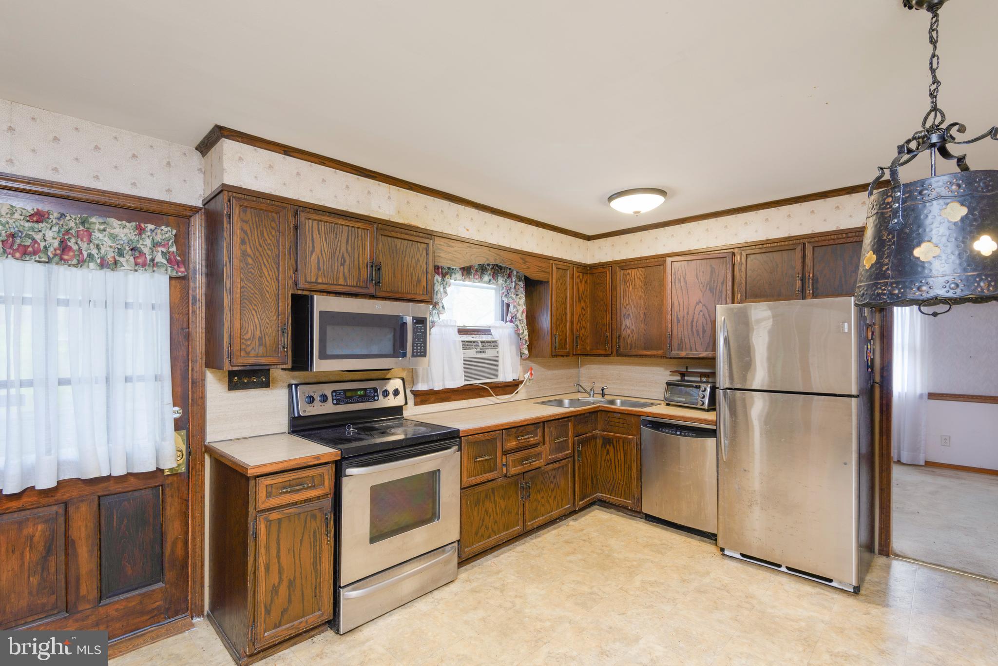 3463 Garnet Mine Road Garnet Valley, PA 19060 - Photo 10 of 38 a kitchen with a sink cabinets stainless steel appliances and a window