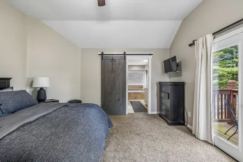 a bedroom with a bed and a television