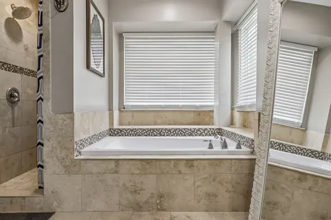 a bathroom with a bathtub and shower