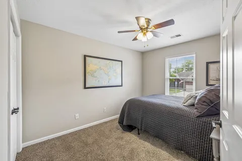 a bedroom with a bed and window