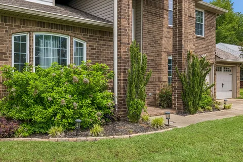 a view of a house with a yard and plants