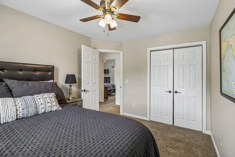 a bedroom with a bed and a chandelier