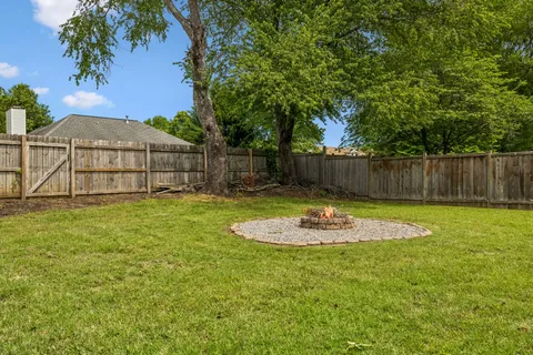 a front view of a house with a yard and sitting area