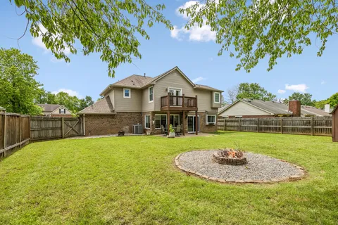 a view of a house with a yard and sitting area