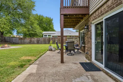 a front view of a house with a garden and yard