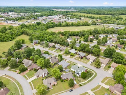an aerial view of a houses with a yard