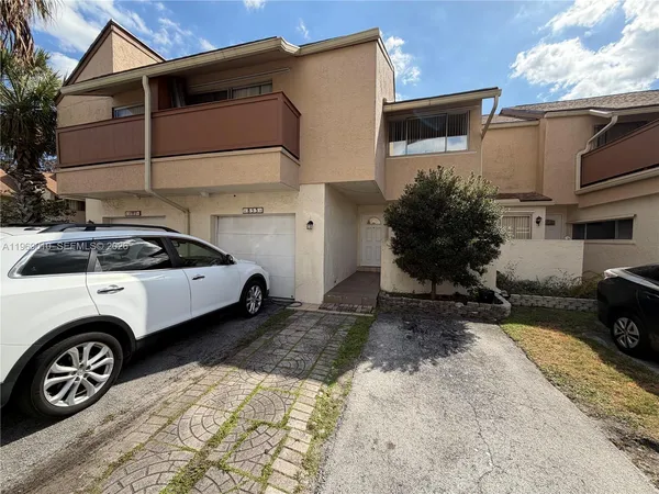 a view of a car parked front of a house