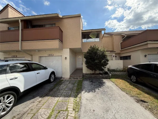 a view of a car park in front of a house