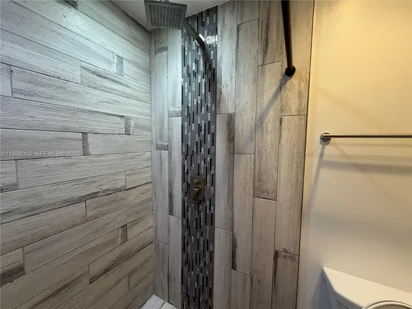 a bathroom with a shower and a glass door