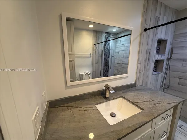 a bathroom with a sink and a mirror