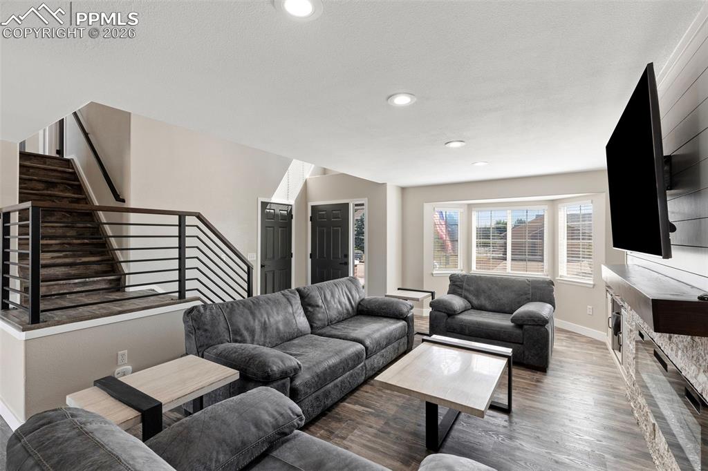 7636 Bullet Road Peyton, CO 80831 - Photo 11 of 30 a living room with furniture ceiling fan and a flat screen tv