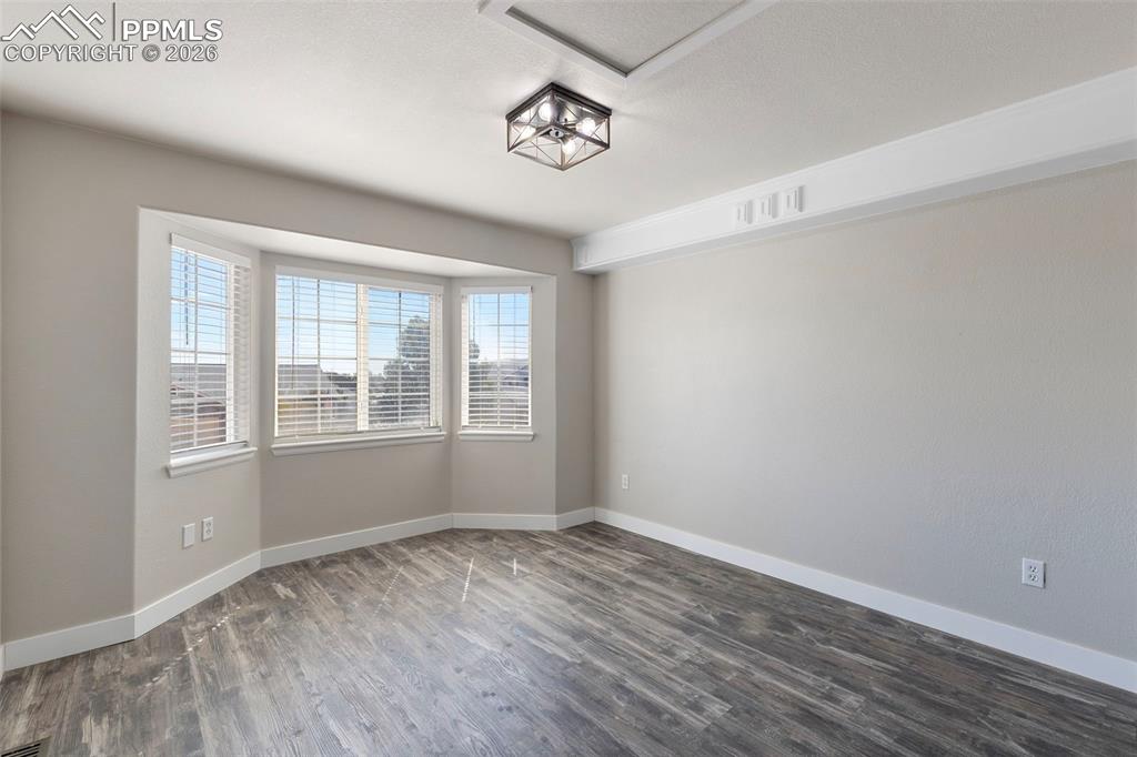 7636 Bullet Road Peyton, CO 80831 - Photo 13 of 30 a view of empty room with wooden floor and fan