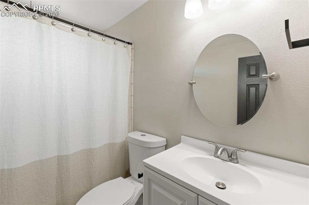 7636 Bullet Road Peyton, CO 80831 - Photo 19 of 30 a bathroom with a sink mirror and toilet