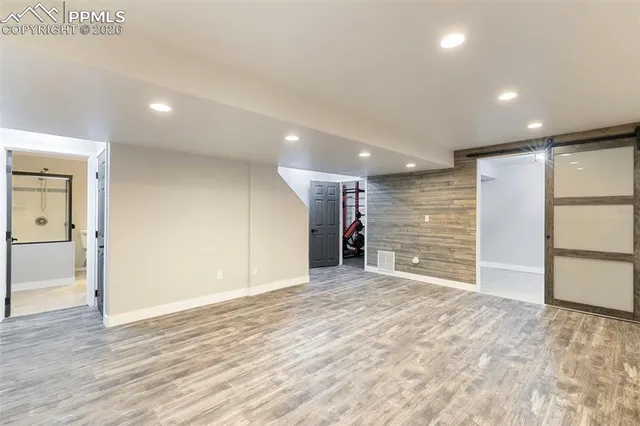 a view of empty room with wooden floor