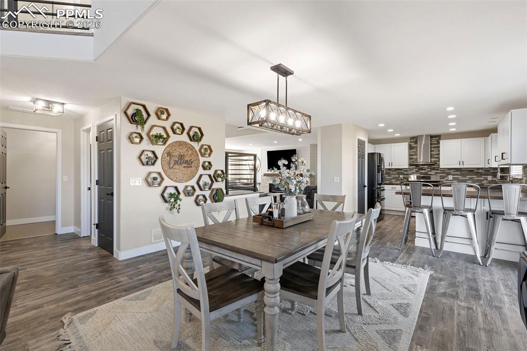 7636 Bullet Road Peyton, CO 80831 - Photo 5 of 30 a view of a dining room with furniture and wooden floor
