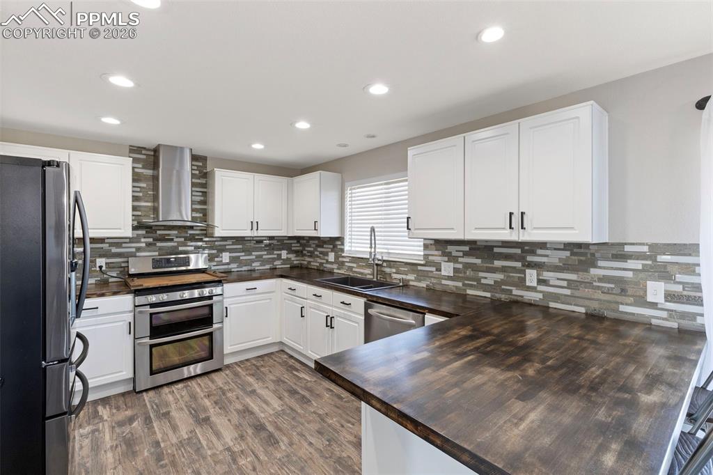 7636 Bullet Road Peyton, CO 80831 - Photo 6 of 30 a kitchen with a sink stove and cabinets