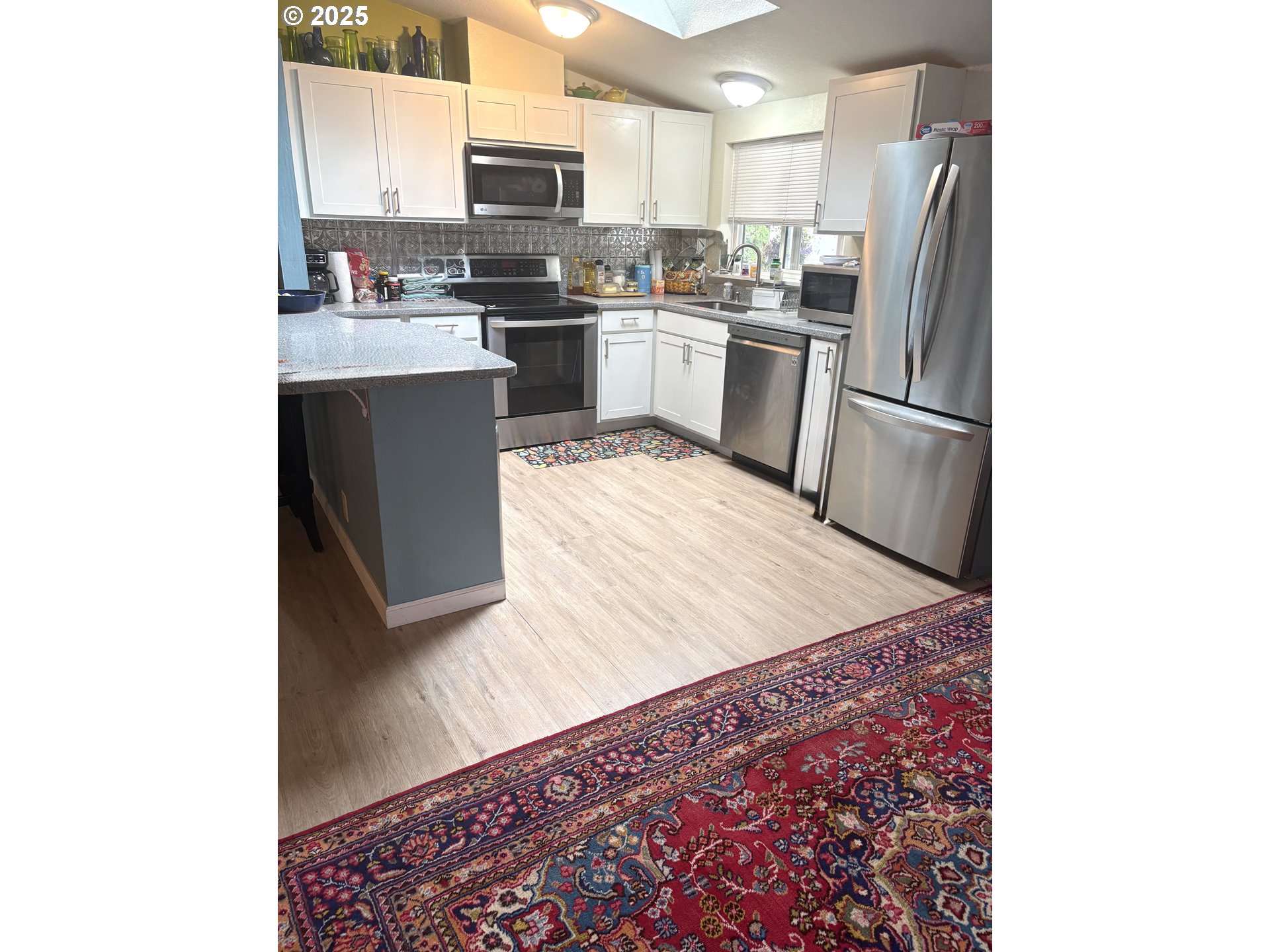 1699 North Terry Street, Unit 272 Eugene, OR 97402 - Photo 2 of 25 a kitchen with stainless steel appliances granite countertop a refrigerator sink and stove