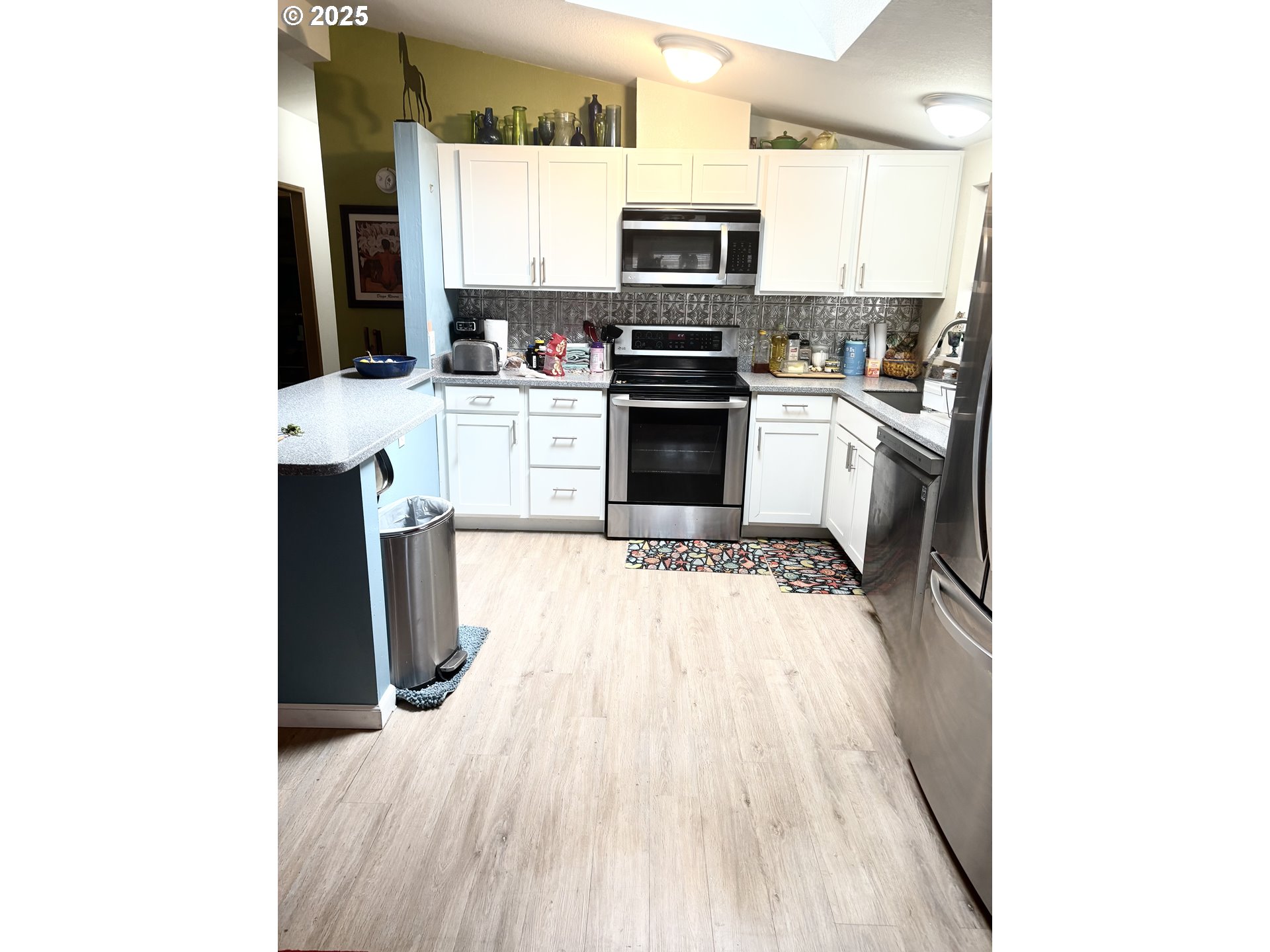 1699 North Terry Street, Unit 272 Eugene, OR 97402 - Photo 23 of 25 a kitchen with stainless steel appliances a refrigerator and a stove top oven