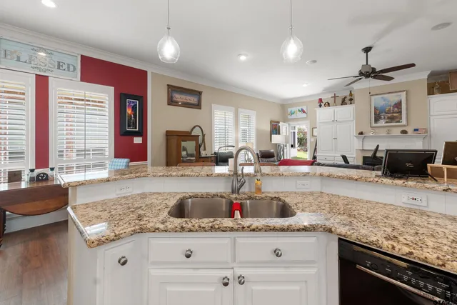 a kitchen with granite countertop a sink and stove