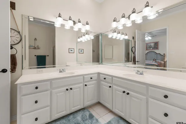 a bathroom with a double vanity sink and a mirror