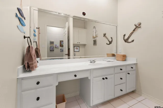 a bathroom with a double vanity sink a mirror a glass door a shower and vanity