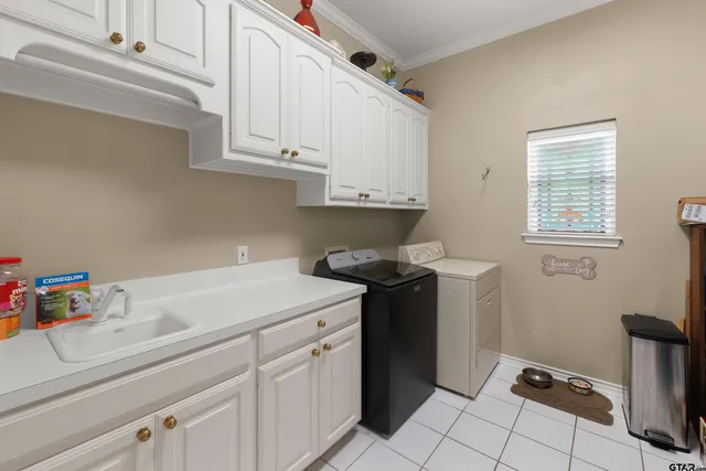 a utility room with sink dryer and washer