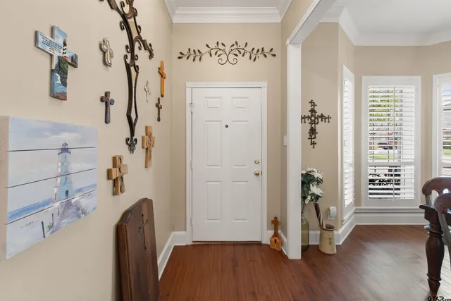 a view of a hallway with wooden floor and windows