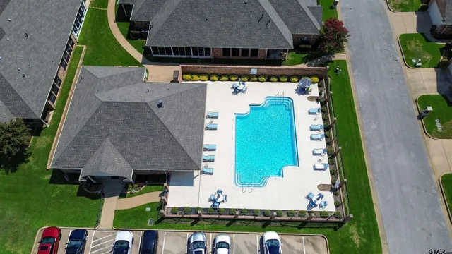 an aerial view of a house with a swimming pool