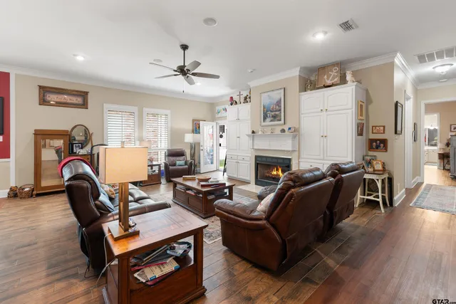 a living room with furniture a fireplace and wooden floor