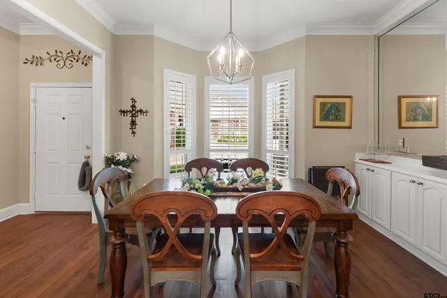 a view of a dining room with furniture and windows