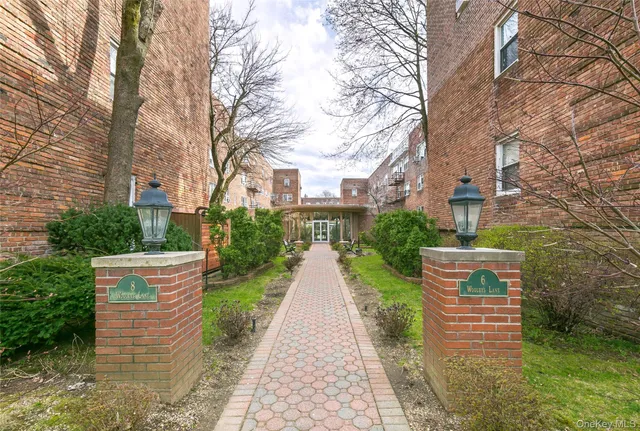 a pathway of a house with brick walls