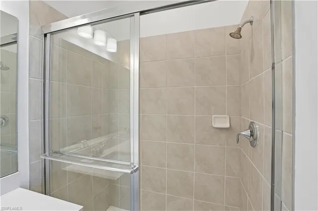 a bathroom with a glass shower door