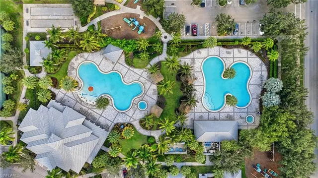 an aerial view of residential houses with outdoor space and trees all around